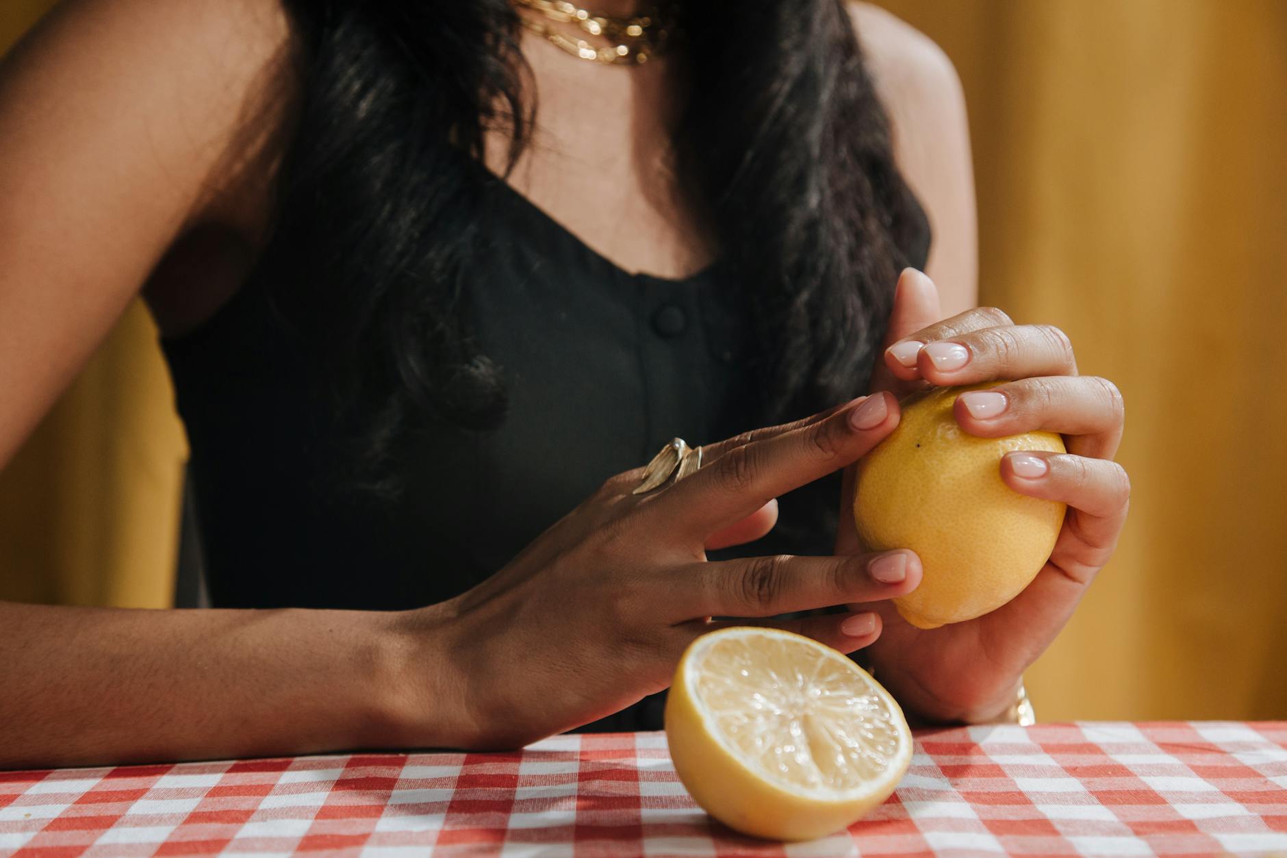 Two women laughing together with lemon slices, expressing confidence and joy